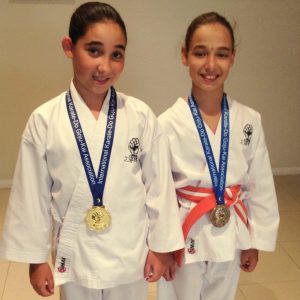 Two young girls started as having competed in Development Tournament with their medals Beginners Karate Kids Perth, well done